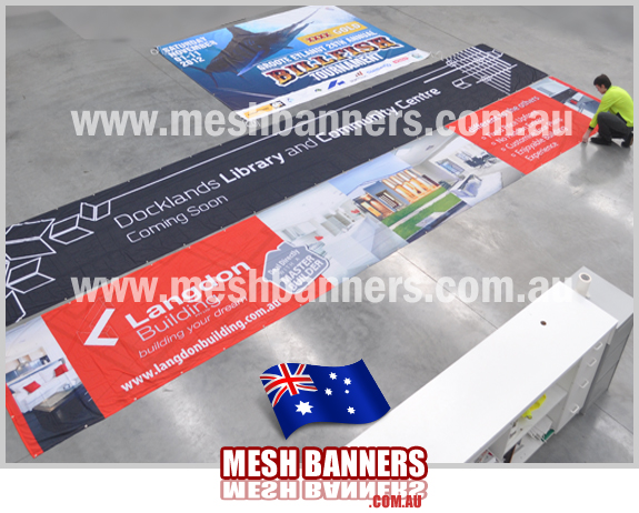 Builders signs on the concrete floor. We make hundreds of fence banner signs and builders signs for designers.