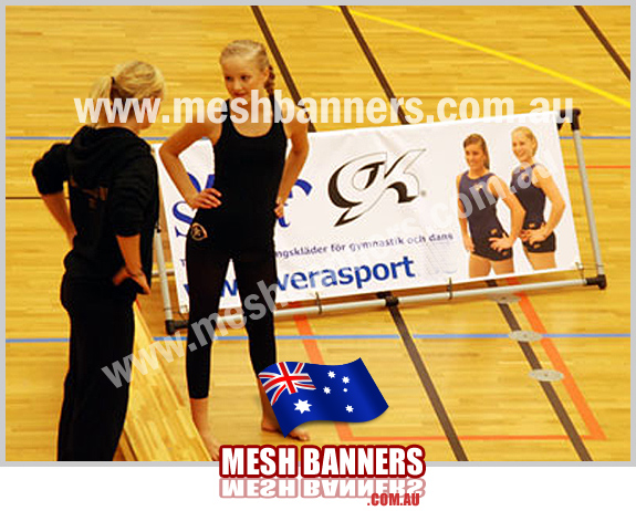 Girls talking with a banner in the background