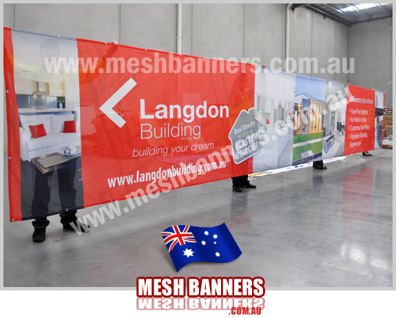 Mesh Banners Factory showing the building company new temporary fence banner sign with house photos, logos and company name