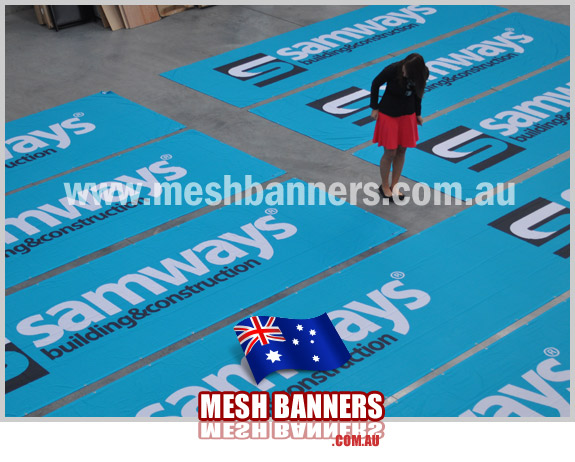 Sign designer looking at the fence signs