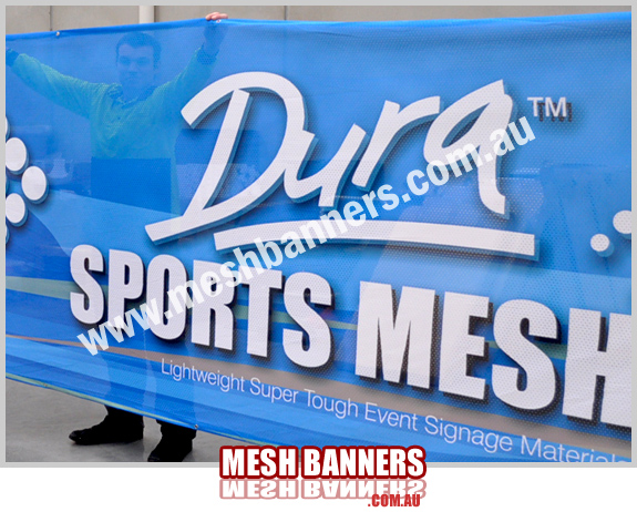 Man behind sports mesh banner sign material
