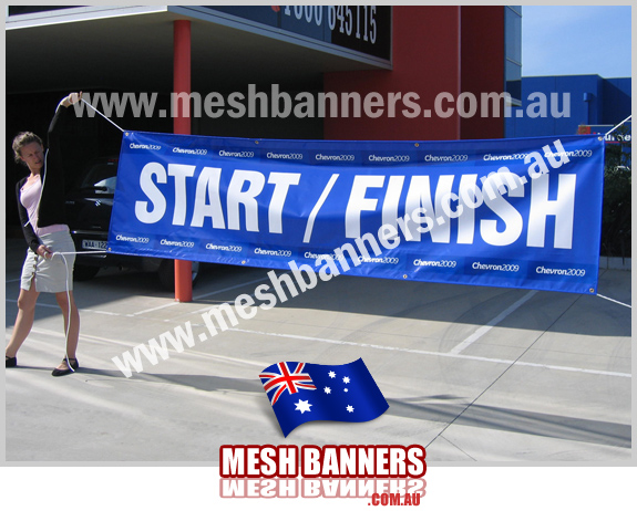 Young woman holding up a START / FINISH line banner
