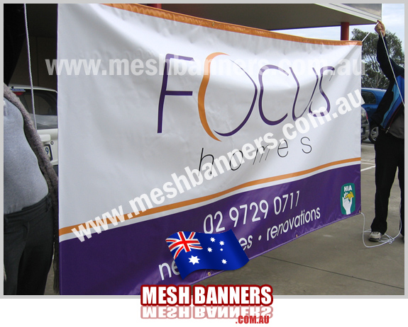 People with temporary fence banner -focus